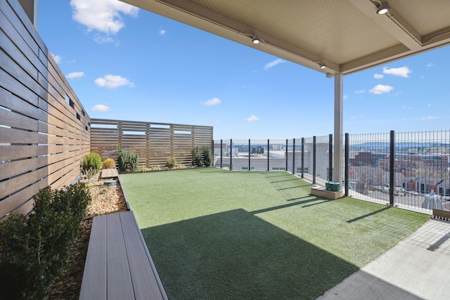 view of yard with a ceiling fan and fence