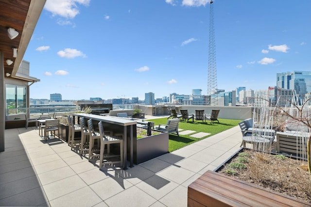 view of patio with a city view and outdoor dining space