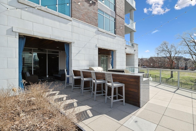 view of patio / terrace featuring outdoor wet bar and an outdoor kitchen