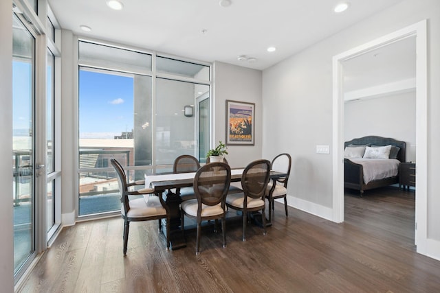 dining area featuring dark wood-type flooring, recessed lighting, baseboards, and expansive windows