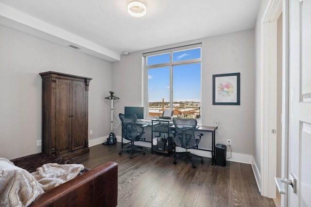 office space featuring wood finished floors, visible vents, and baseboards