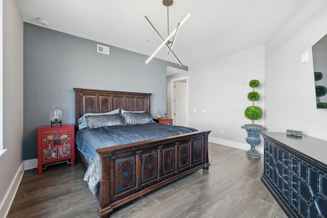 bedroom featuring visible vents, wood finished floors, and baseboards