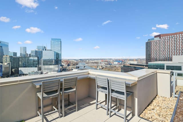 balcony with outdoor dry bar and a city view