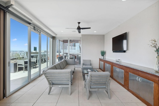 living area featuring light tile patterned floors and a ceiling fan