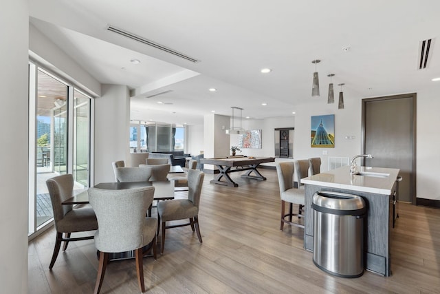 dining area with recessed lighting, visible vents, and wood finished floors