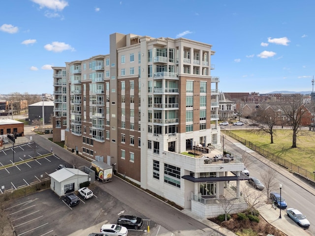 view of building exterior with uncovered parking