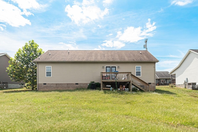 rear view of property with crawl space, stairway, a lawn, and a wooden deck