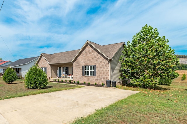 single story home with brick siding and a front lawn