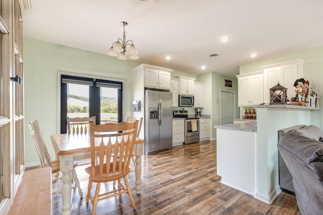 kitchen with visible vents, dark wood-type flooring, recessed lighting, appliances with stainless steel finishes, and an inviting chandelier