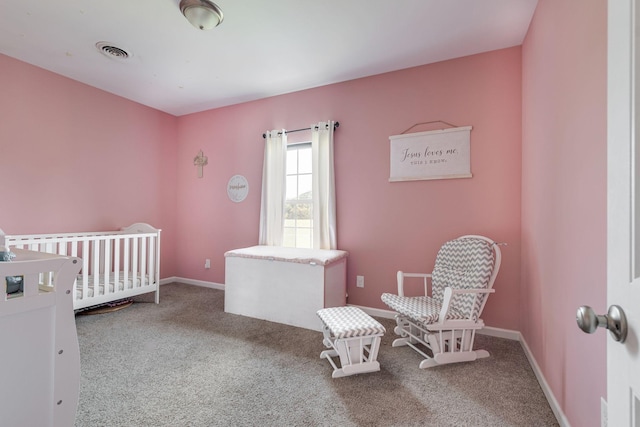 bedroom with visible vents, carpet floors, a nursery area, and baseboards