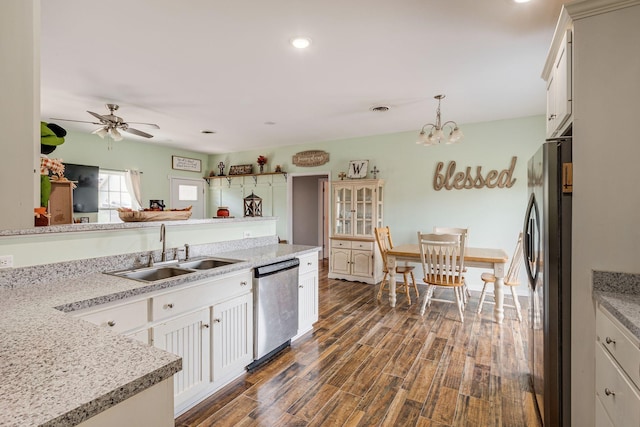 kitchen with dark wood finished floors, appliances with stainless steel finishes, light countertops, and a sink