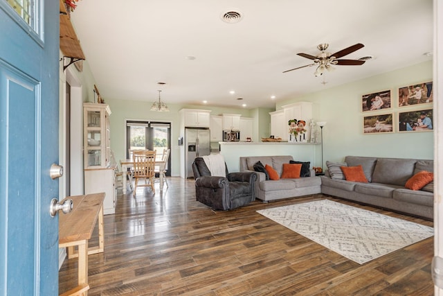 living room with ceiling fan, visible vents, dark wood-style floors, and recessed lighting