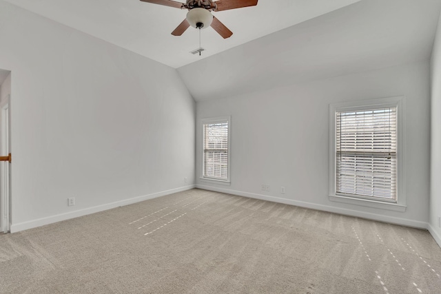 unfurnished room with baseboards, lofted ceiling, a ceiling fan, and carpet flooring