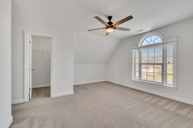 additional living space featuring baseboards, carpet, visible vents, and ceiling fan