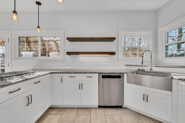 kitchen featuring open shelves, a sink, stainless steel appliances, white cabinets, and tasteful backsplash