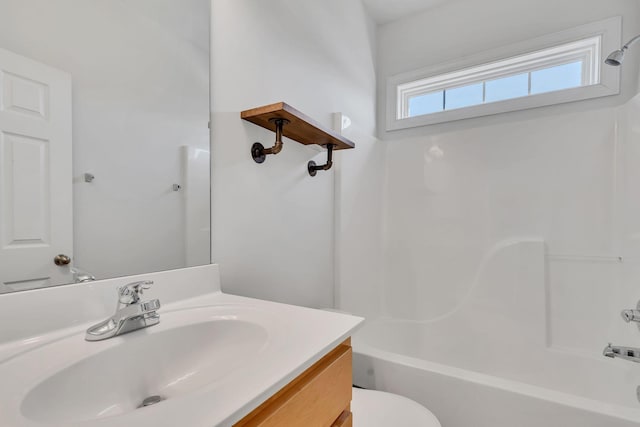 bathroom with bathing tub / shower combination, toilet, and vanity