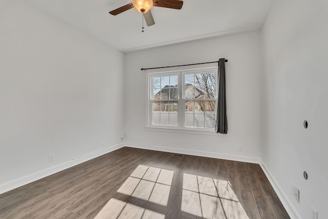 empty room with wood finished floors, baseboards, and ceiling fan