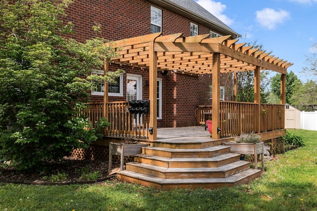 wooden terrace featuring a lawn and a pergola