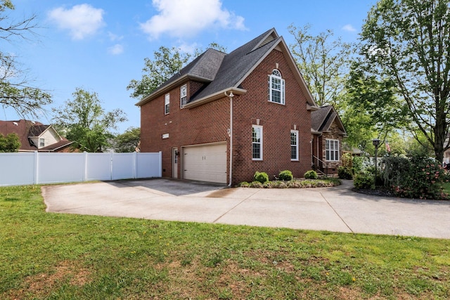 view of side of property featuring concrete driveway, fence, a garage, brick siding, and roof with shingles