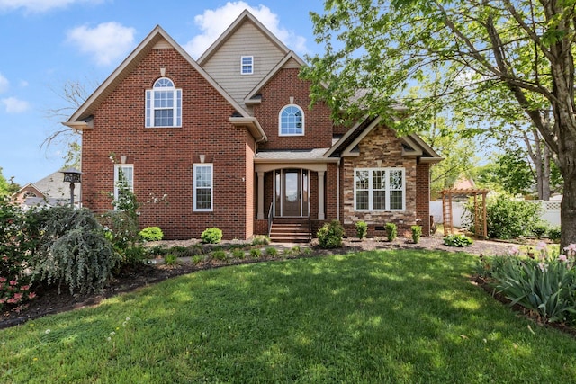 view of front of property featuring brick siding and a front yard