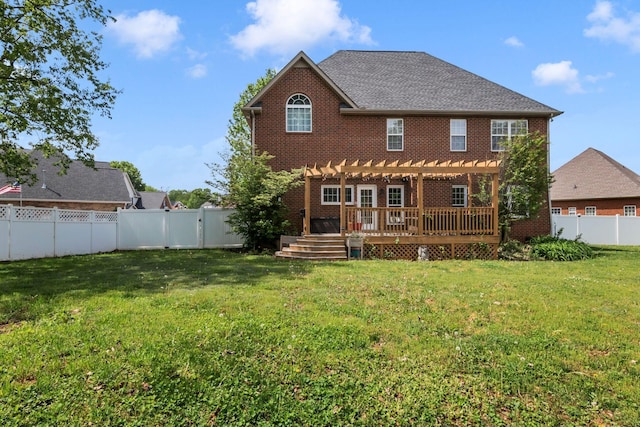 back of house featuring a pergola, a yard, a wooden deck, and a fenced backyard