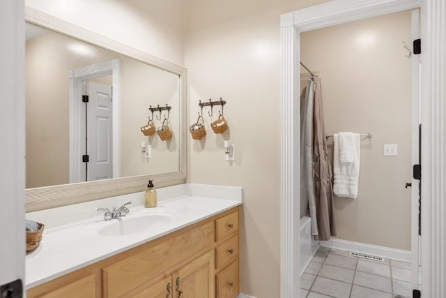 full bathroom featuring vanity, visible vents, baseboards, shower / bath combo, and tile patterned floors