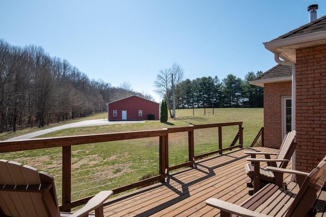 wooden deck with a lawn and an outdoor structure