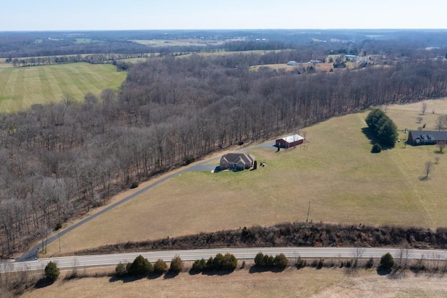 aerial view featuring a view of trees and a rural view