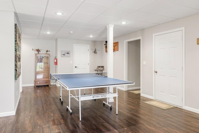 rec room with a drop ceiling, recessed lighting, baseboards, and wood finished floors