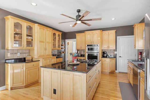 kitchen with light wood-style floors, a ceiling fan, appliances with stainless steel finishes, and light brown cabinetry