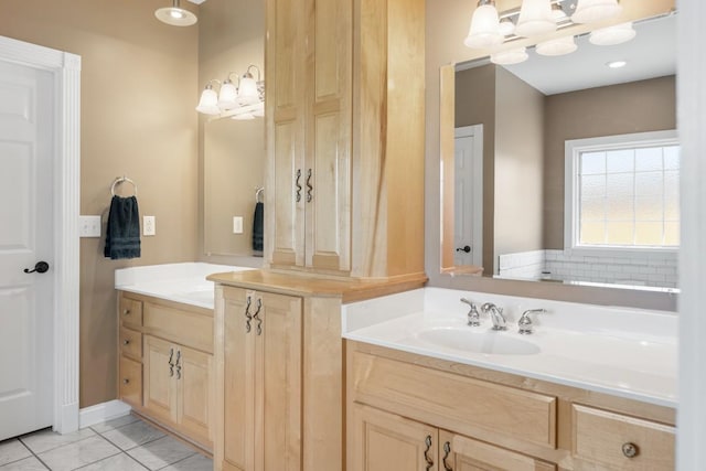 full bathroom featuring a sink and two vanities