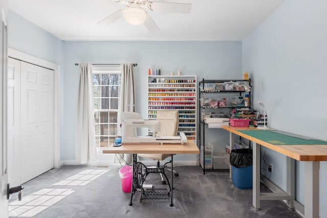 office with a ceiling fan and carpet