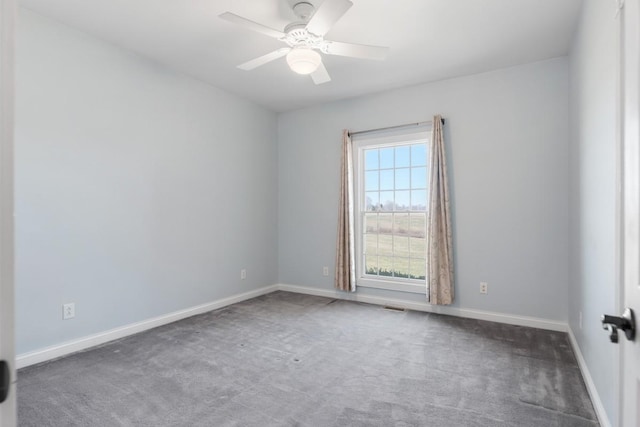 unfurnished room featuring visible vents, carpet flooring, a ceiling fan, and baseboards