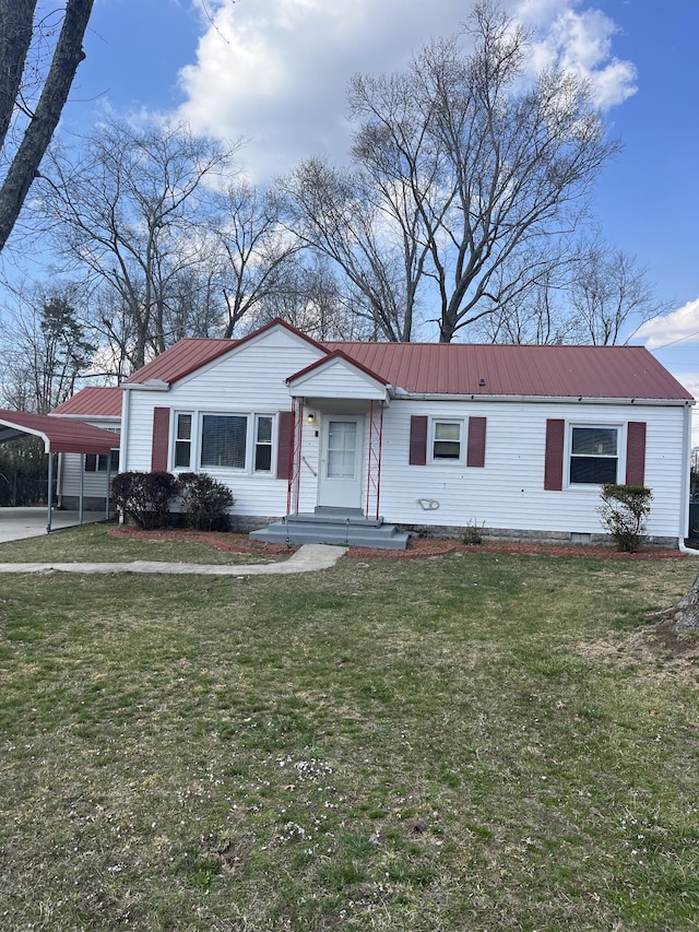 view of front of house featuring crawl space, metal roof, a carport, and a front lawn