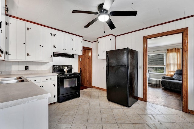 kitchen with under cabinet range hood, light countertops, a ceiling fan, a sink, and black appliances