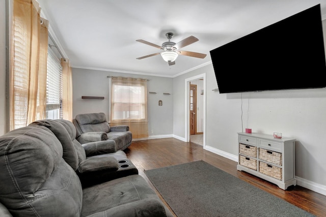 living room featuring dark wood finished floors, ornamental molding, and ceiling fan