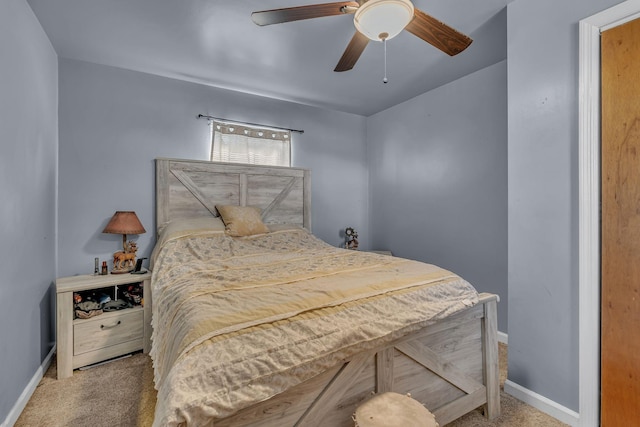 bedroom with ceiling fan, baseboards, and carpet flooring