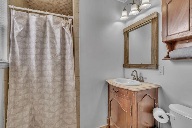 bathroom featuring vanity, curtained shower, and toilet