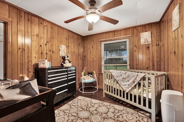 bedroom with wooden walls and ceiling fan