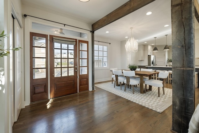 entrance foyer featuring recessed lighting, a notable chandelier, beamed ceiling, and dark wood-style flooring