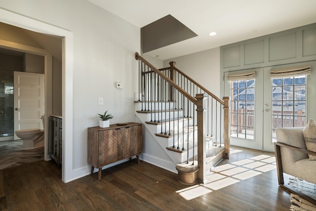 stairway featuring wood finished floors, french doors, and baseboards