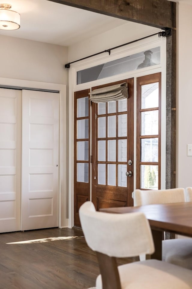 unfurnished dining area featuring french doors and dark wood finished floors