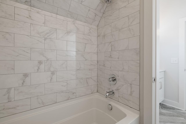 full bath with marble finish floor, shower / bathtub combination, and baseboards