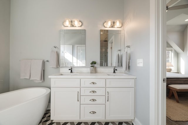 bathroom with ensuite bath, double vanity, a tile shower, and a sink