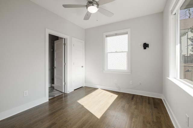 spare room featuring baseboards, a ceiling fan, and wood finished floors