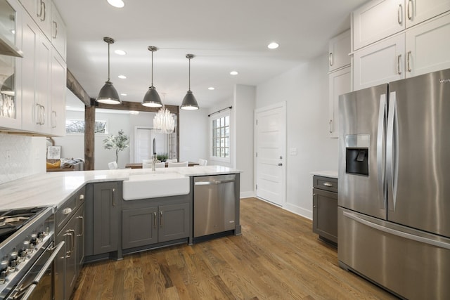 kitchen featuring a sink, glass insert cabinets, recessed lighting, stainless steel appliances, and dark wood-style flooring