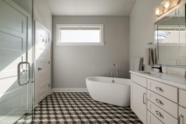 bathroom with a healthy amount of sunlight, a stall shower, a freestanding bath, and vanity