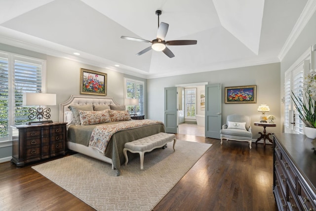 bedroom featuring ceiling fan, a tray ceiling, dark wood-style flooring, and ornamental molding