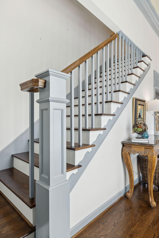 stairway with baseboards and wood finished floors