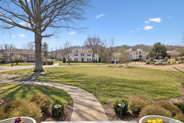 surrounding community featuring a residential view and a lawn